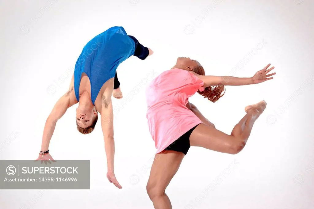 Man doing a somersault with woman jumping