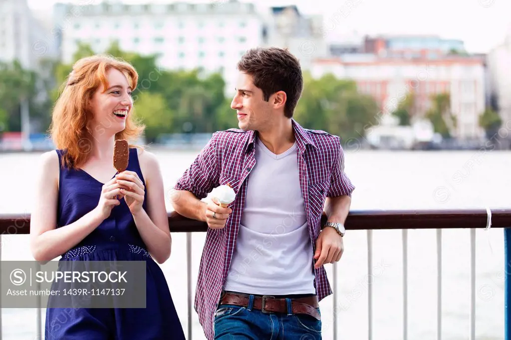 Young couple eating a lolly and an icecream