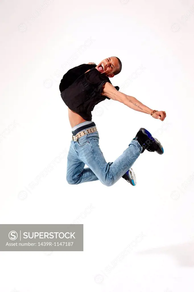 Jubilant young man in mid air