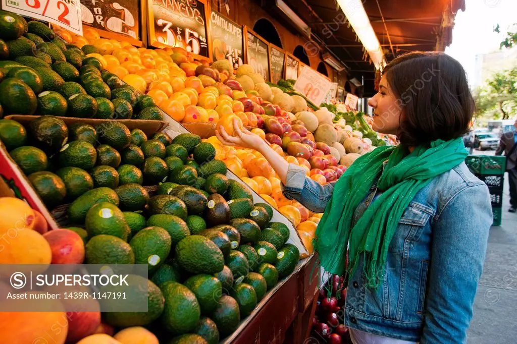 Young woman shopping at market stall