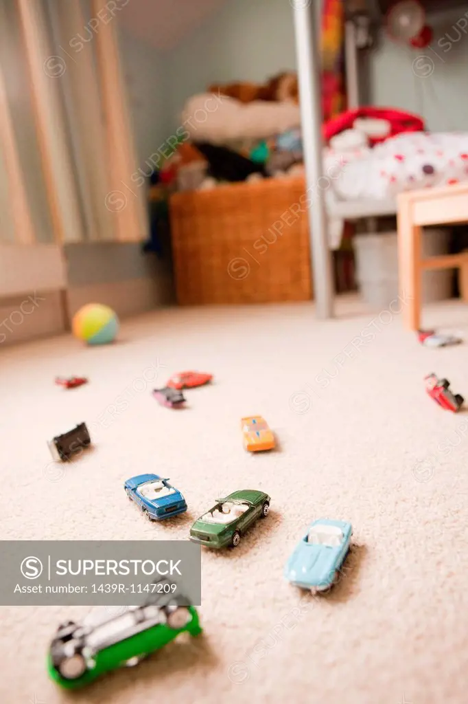 Toy cars scattered across a child´s bedroom