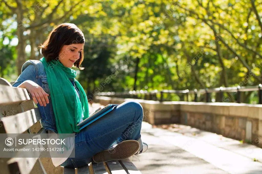 Young woman reading in park