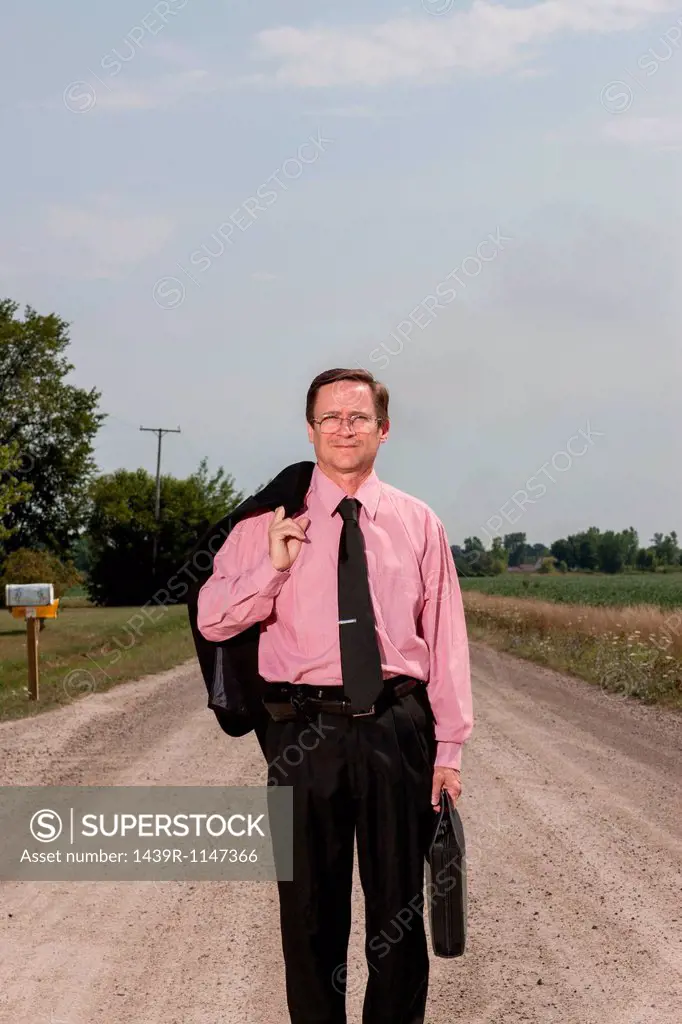 Businessman on country road
