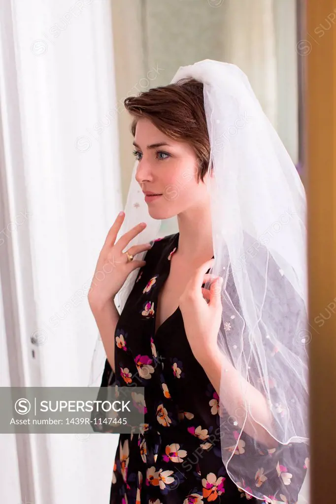 Young woman wearing a bridal veil
