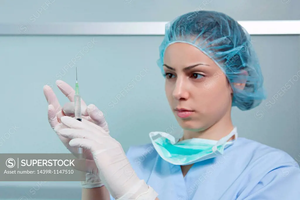 Surgeon holding injection