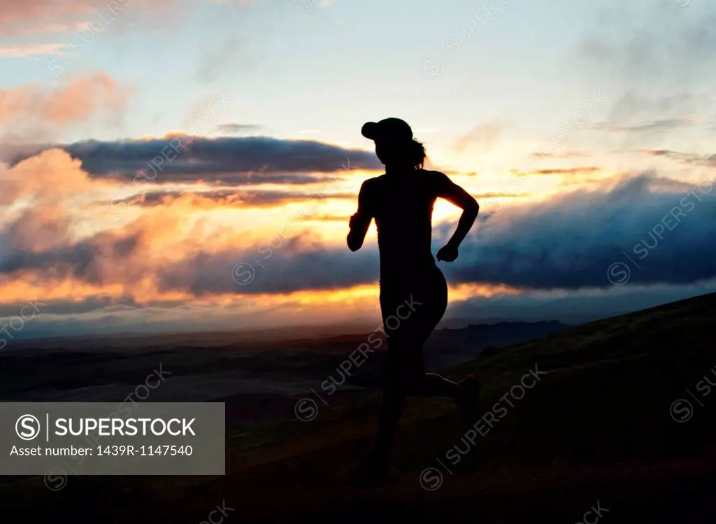 Woman running outside, silhouette