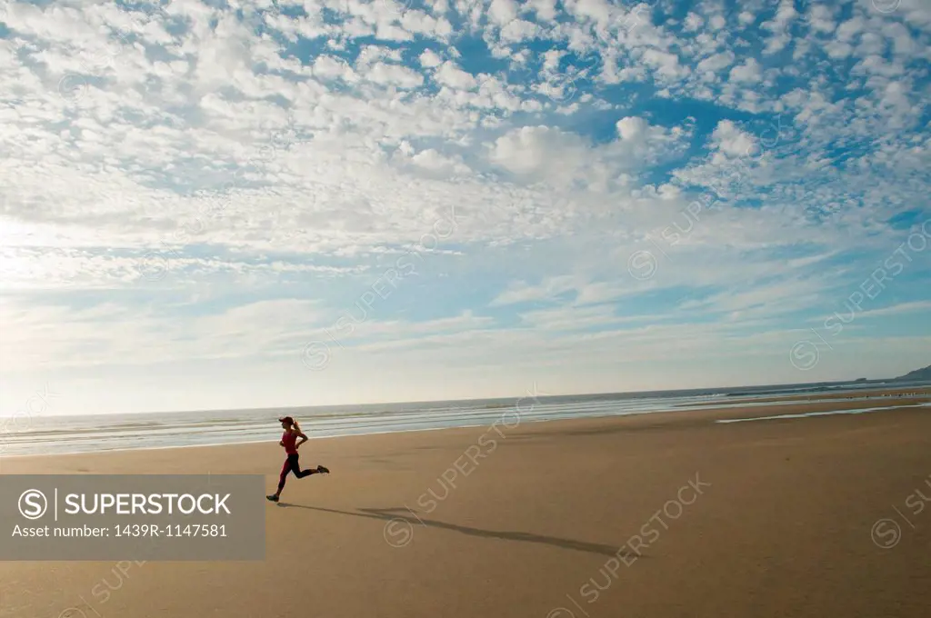 Young woman running on beach