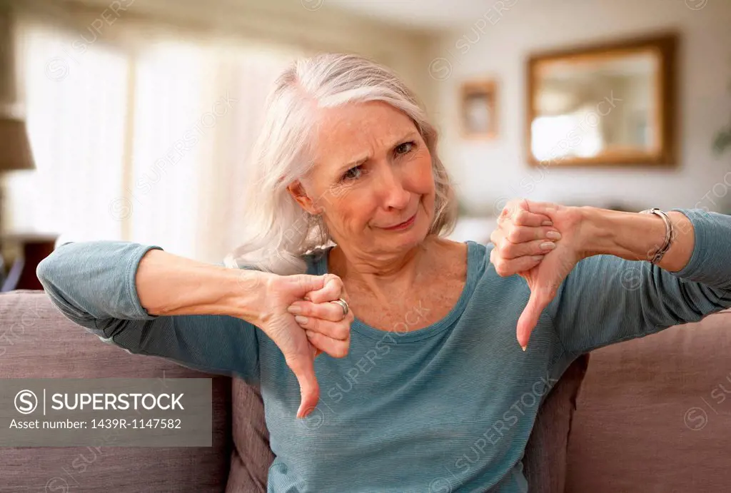Senior woman with thumbs down