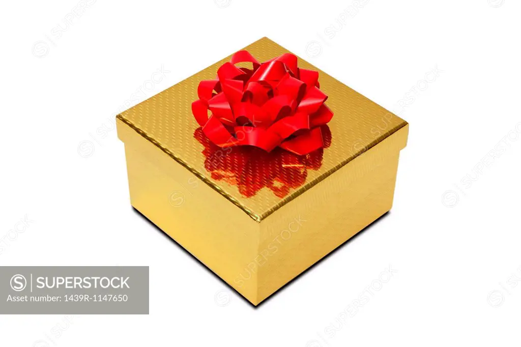 Golden gift box with red bow