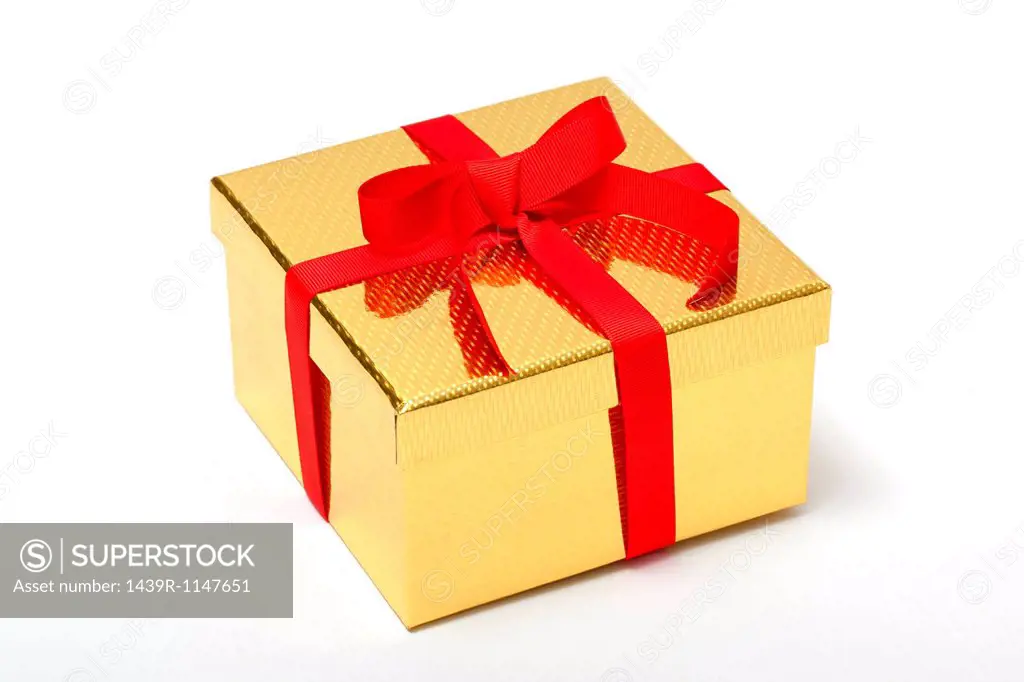 Golden gift box with red ribbon