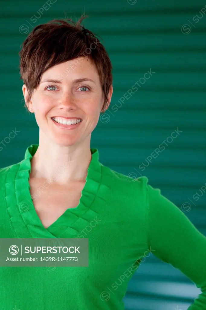Woman against green background, portrait