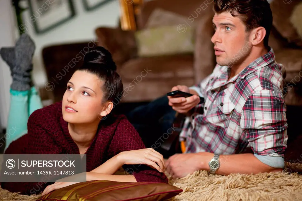 Young couple watching televsion