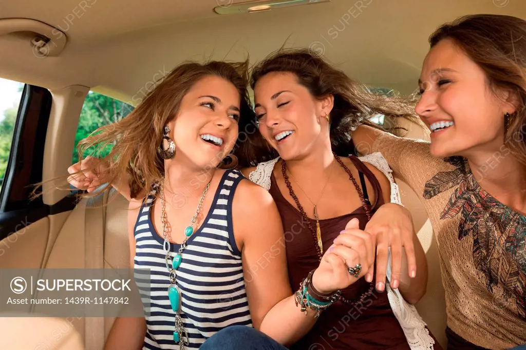 Three girls in back seat of car