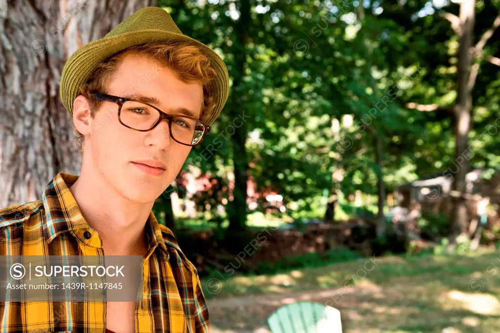 Young man wearing eyeglasses and fedora