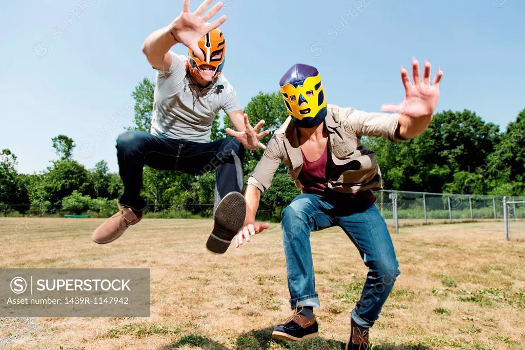 Two young men wearing wrestling masks