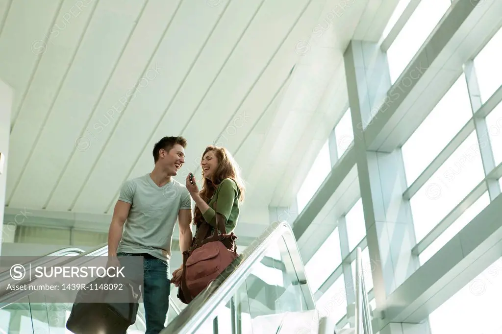 Young couple travelling on escalator