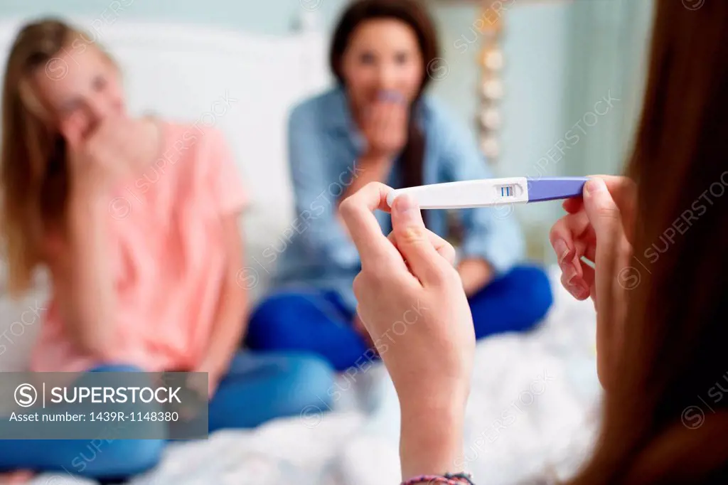 Teenage girl with pregnancy test