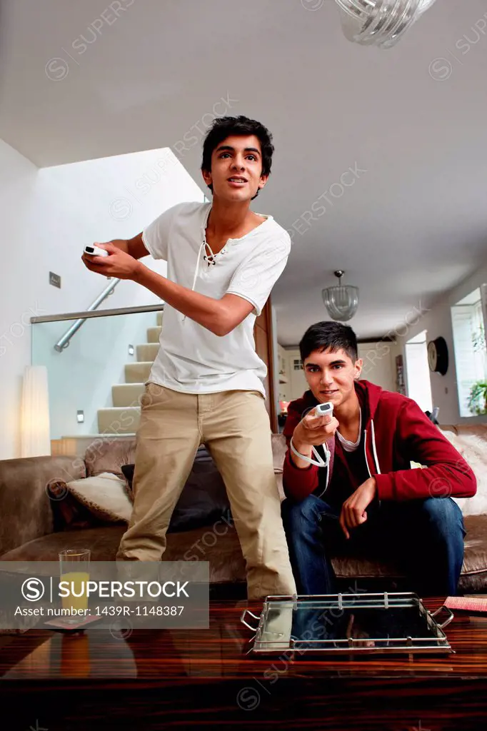 Teenage boys playing video game