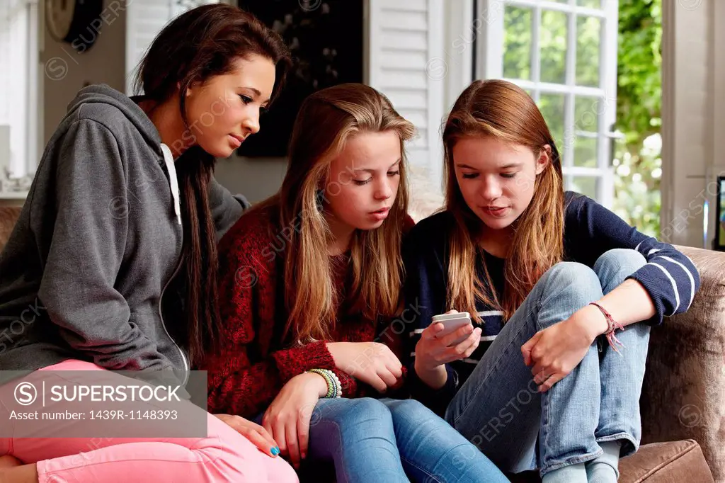 Teenage girls looking at a cellphone