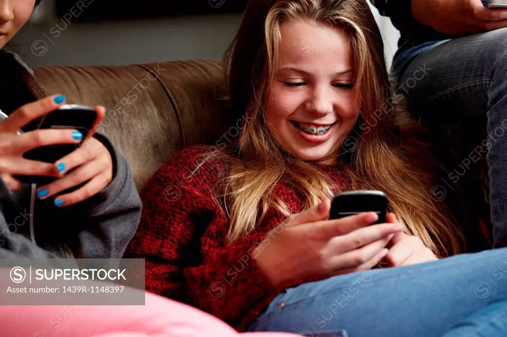Teenage girls using smartphones