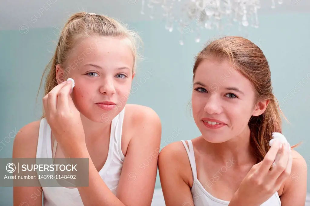 Teenage girls cleansing their faces