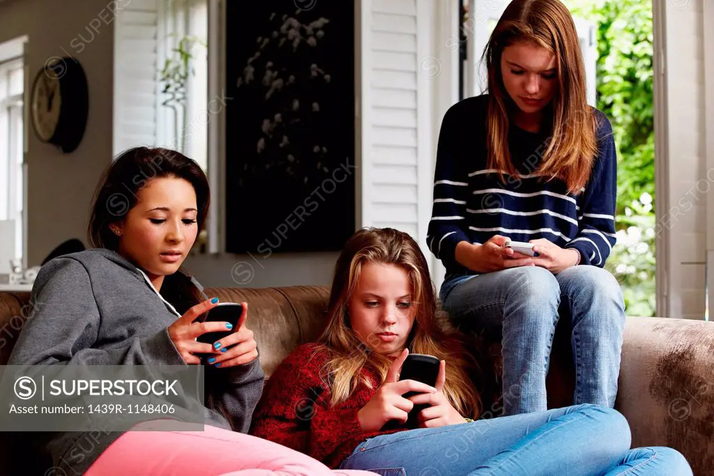Teenage girls using cellphones