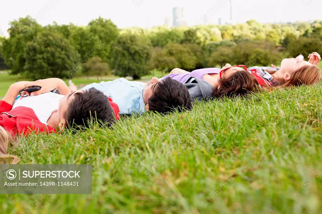 Teenagers lying in a park