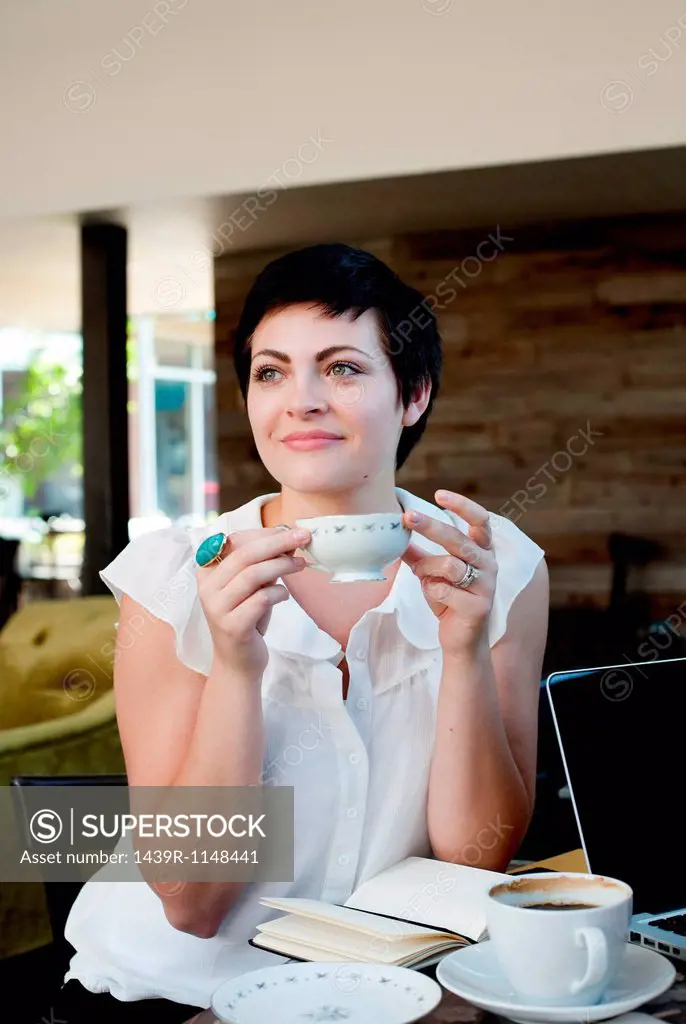 Young woman in cafe with tea