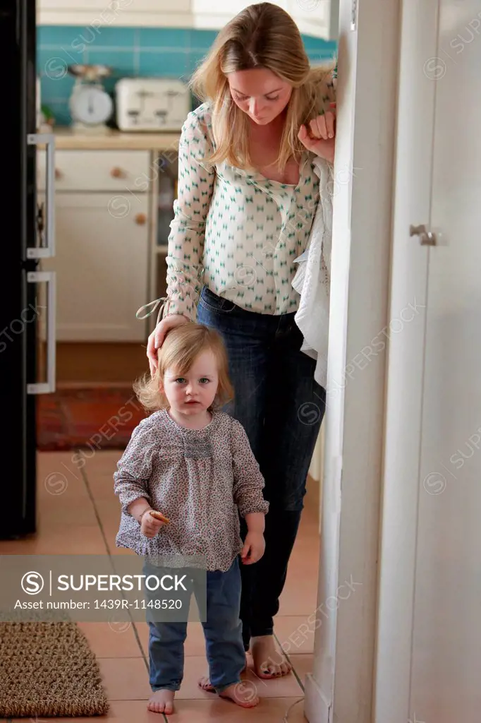Mother and daughter standing in doorway