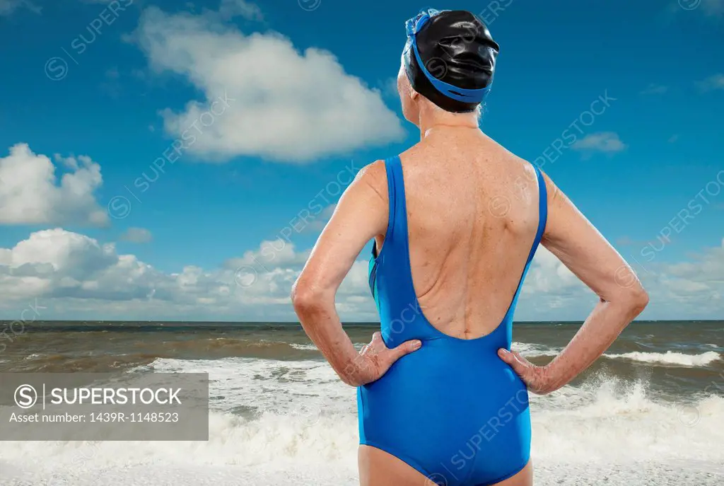 Senior woman wearing swimsuit looking towards sea