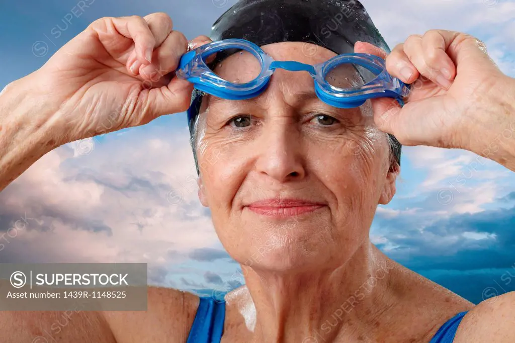 Senior woman adjusting swimming goggles