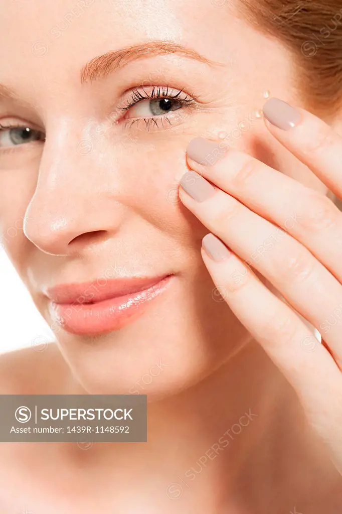 Woman applying eye gel