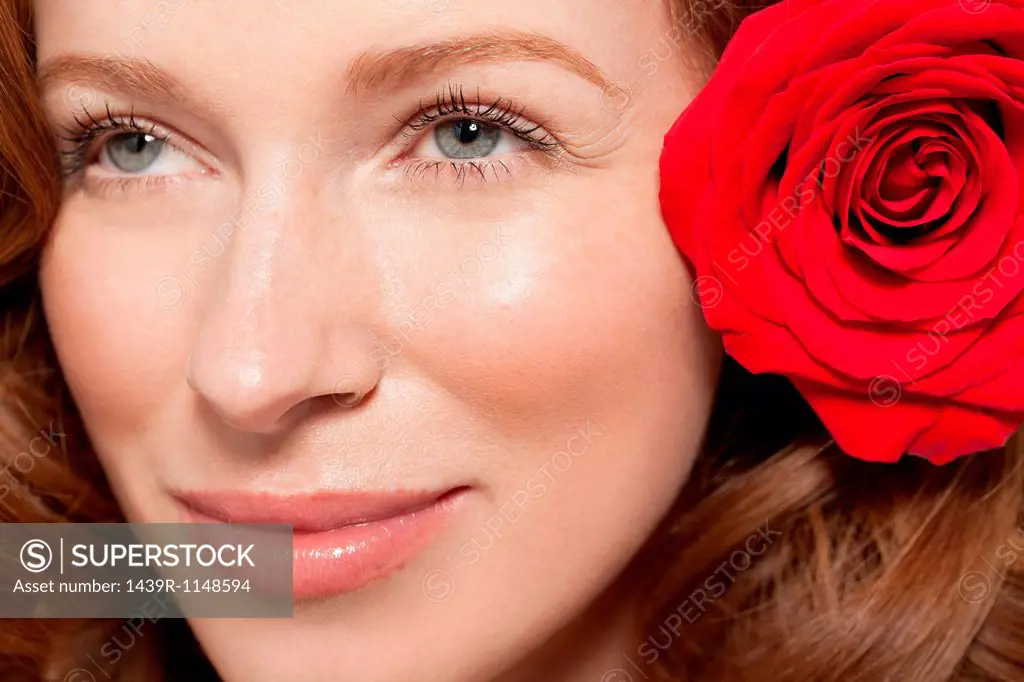 Woman wearing red rose in her hair