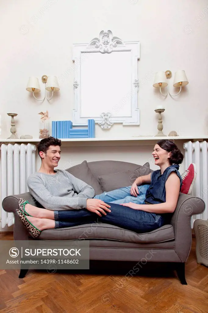 Couple laughing on sofa