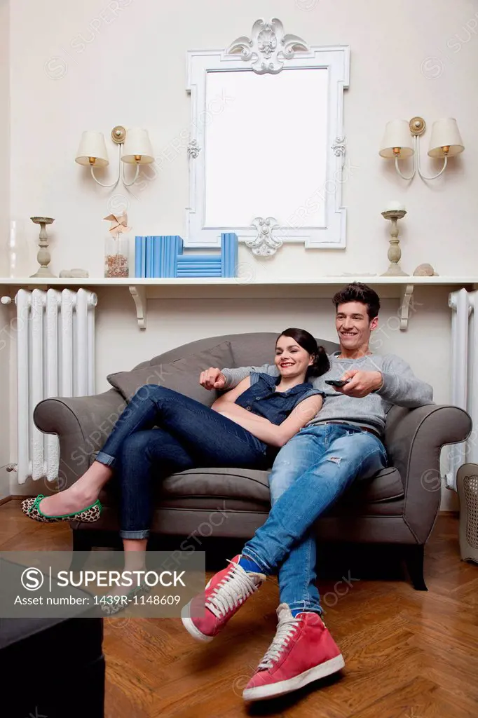 Couple watching tv on sofa