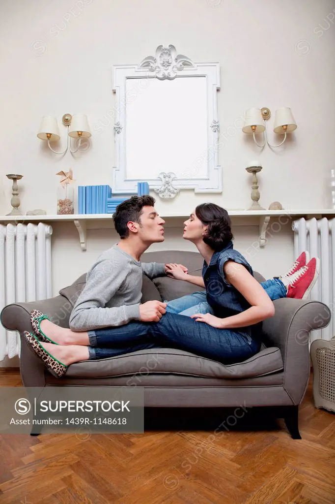 Couple on sofa kissing