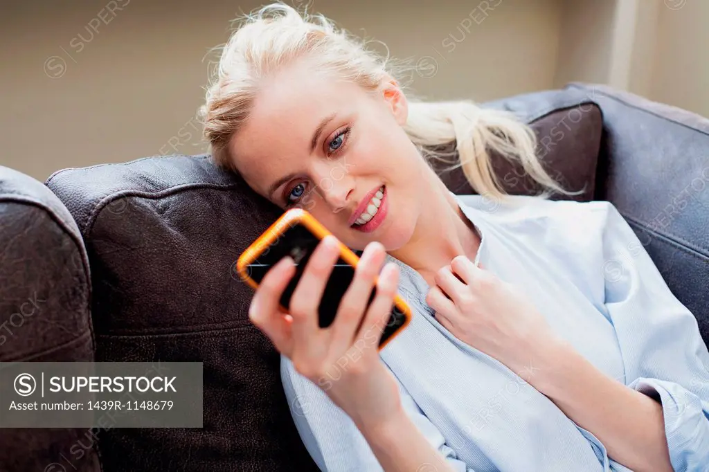 Young woman looking at smartphone and smiling