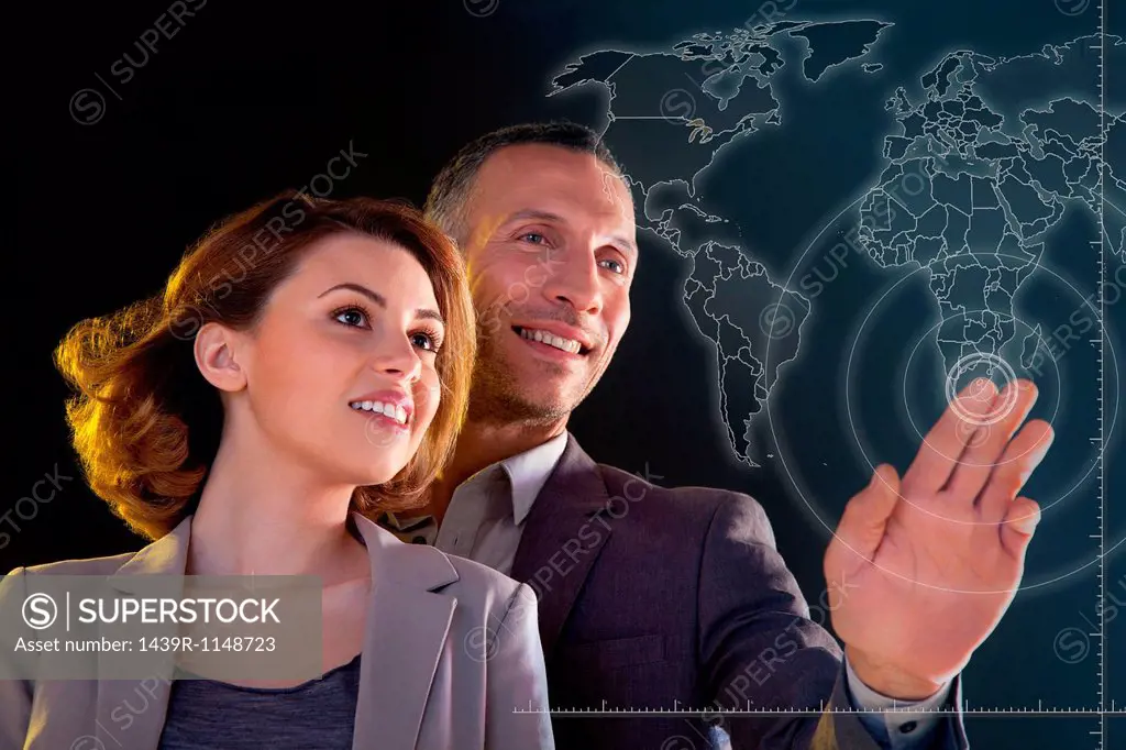 Businesspeople touching world map
