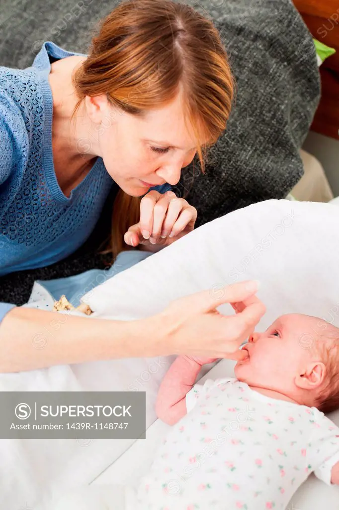 Mother comforting newborn daughter
