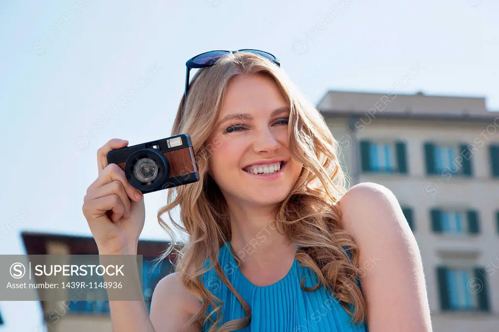 Young woman holding vintage camera