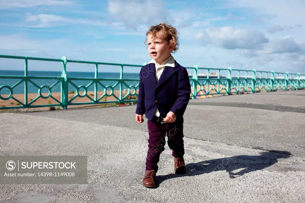 Little boy walking promenade in mod clothing