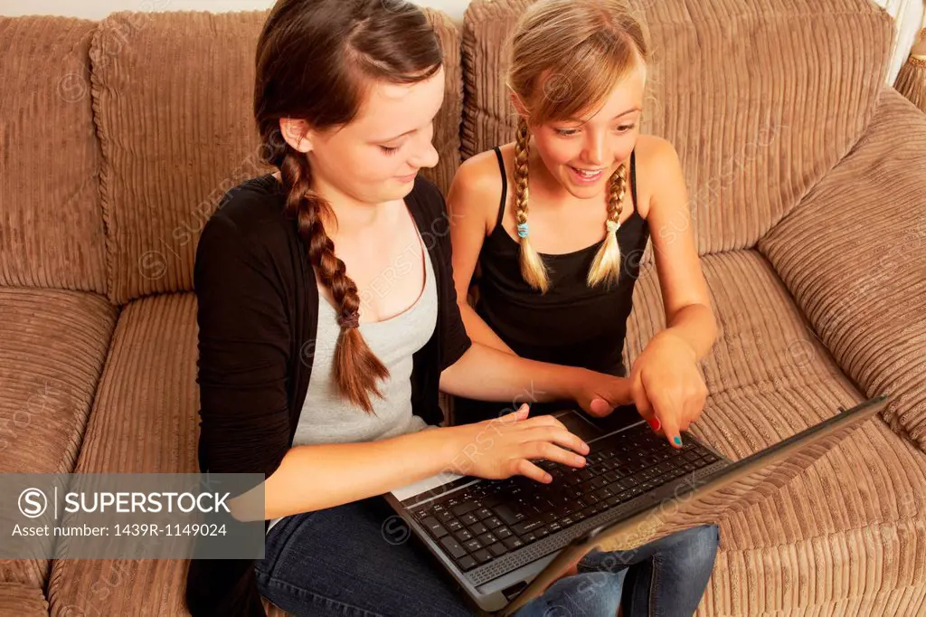 Two girls using laptop