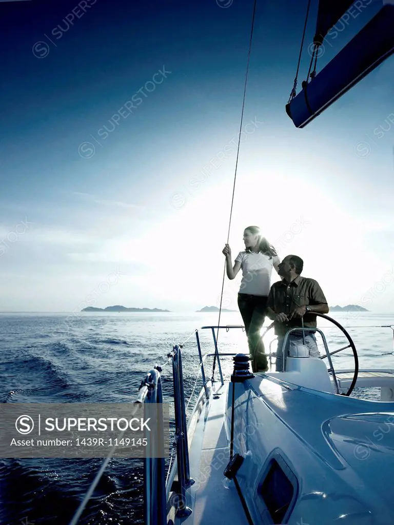 Couple steering a yacht