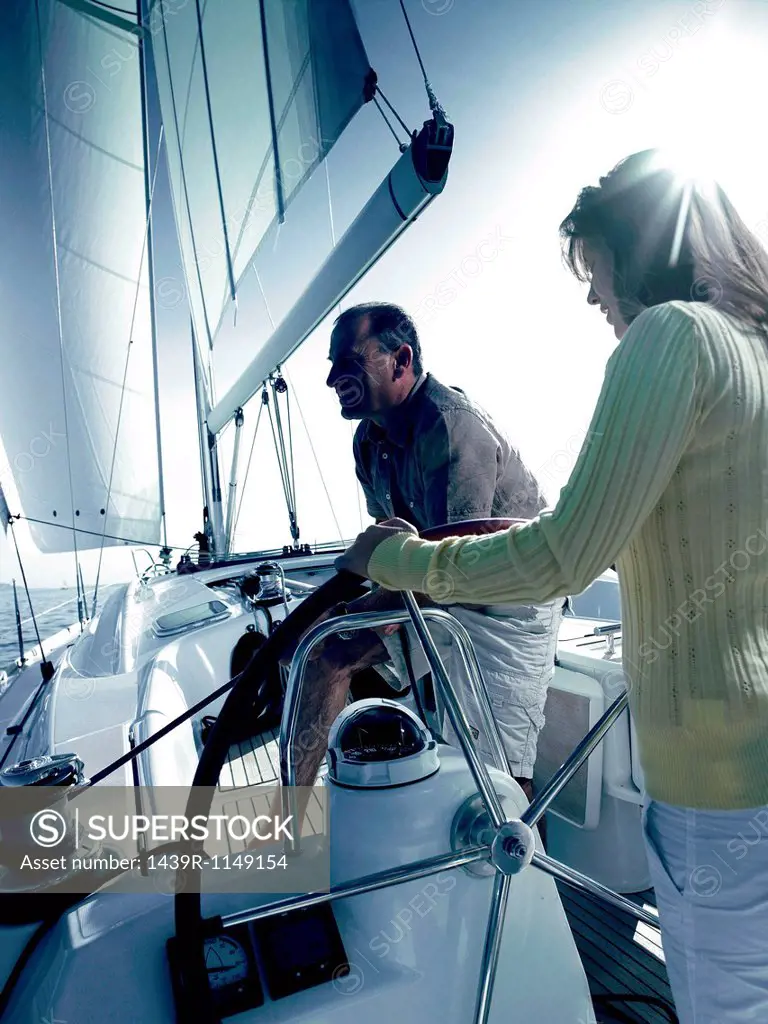 Couple sailing a yacht