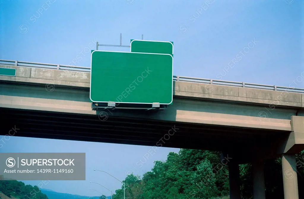 Blank exit sign on highway overpass