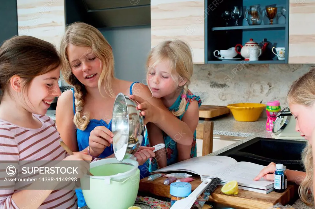 Four girls baking in kitchen