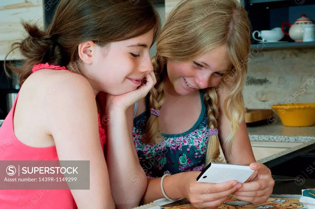 Two girls looking at smartphone
