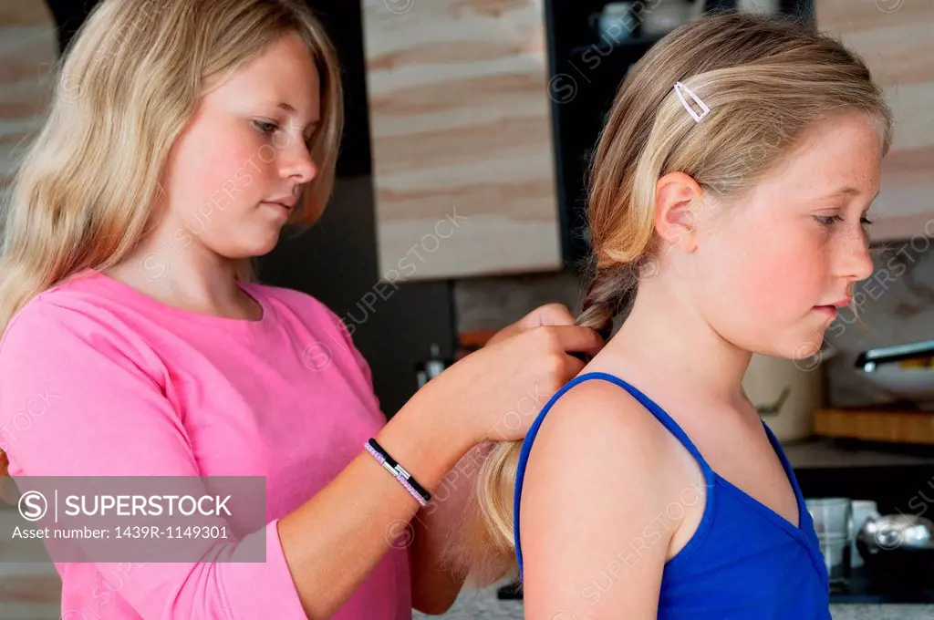 Girl plaiting friends hair