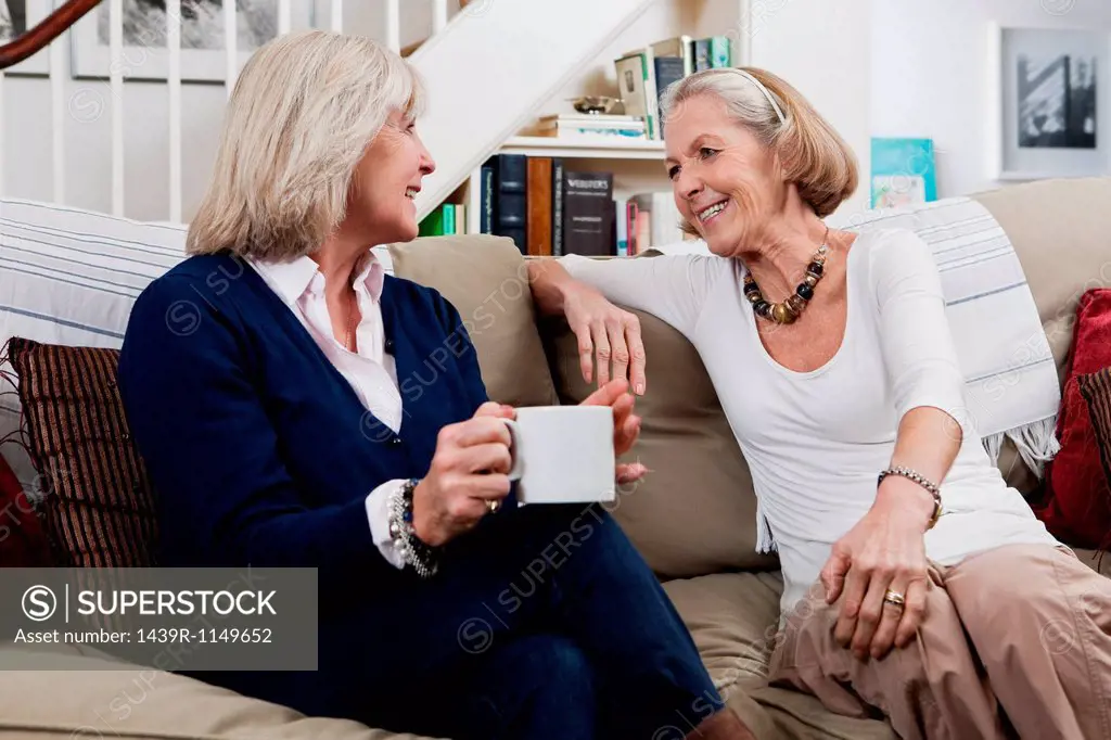 Senior female friends having coffee and a chat