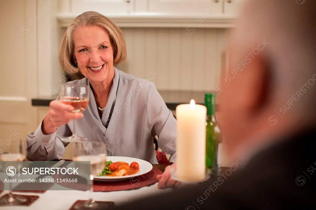 Senior woman with wine at dinner